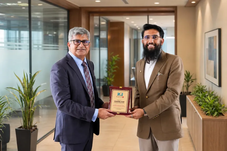 Two executives holding an IGI Insurance plaque